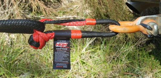 10,000KG HDX Soft Shackle | SaberPro® connected to a tow hook with black and red Technora binding and SaberPro fiber rope.