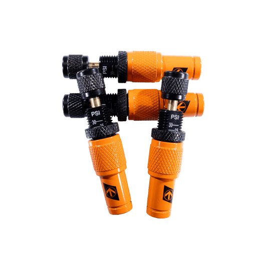 Orange tire deflation tools with PSI adjustment knobs.