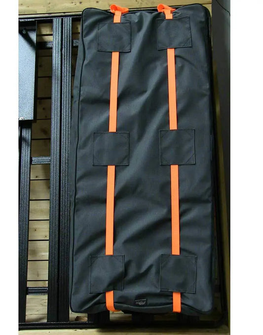Durable black gear bag with orange straps for rooftop cargo systems