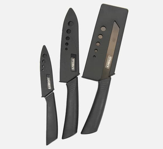 Set of three black knives with protective covers for safe handling.