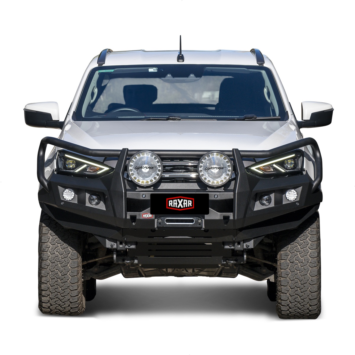 White pickup truck with rugged bull bar and mounted auxiliary lights.