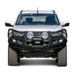 White pickup truck with rugged bull bar and mounted auxiliary lights.