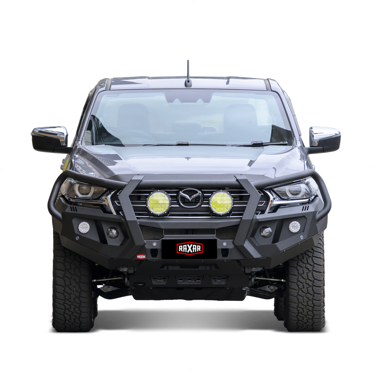 Mazda pickup with rugged bull bar and mounted auxiliary lights.