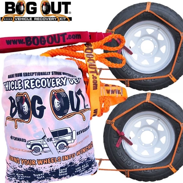 BOG OUT recovery kit with rope, orange straps, and bag beside two car wheels.