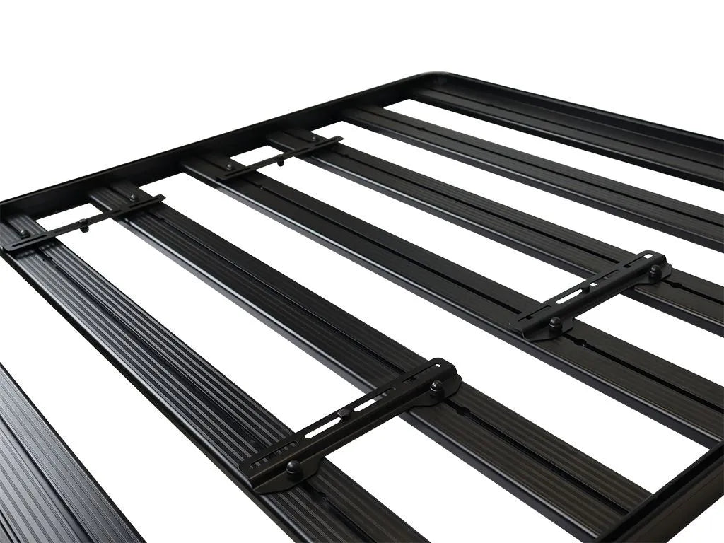 Flat roof rack with slats, mounted solar panel in center.