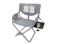 Grey folding chair with armrests and side table holding a wine glass.