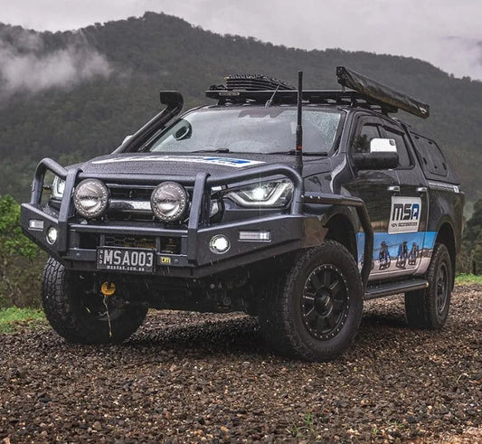 4x4 vehicle featuring heavy-duty bumper, winch, and rain-ready accessories