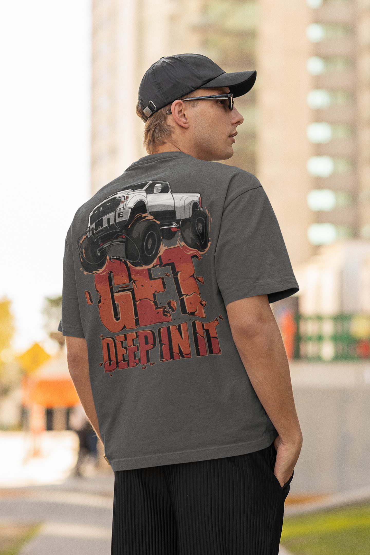 Man wearing a "Get Deep In It" graphic off-road-themed t-shirt.