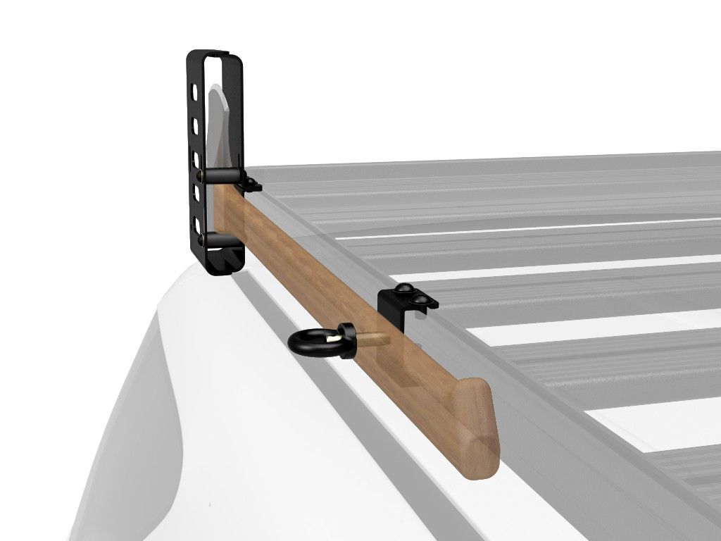 Close-up of wooden plank mounted with black metal brackets on a roof rack.
