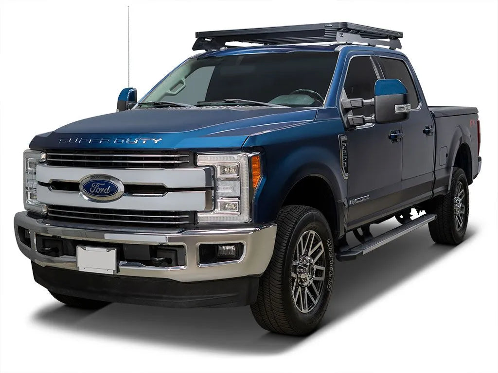 Blue Ford Super Duty truck with roof rack, chrome accents, crew cab.