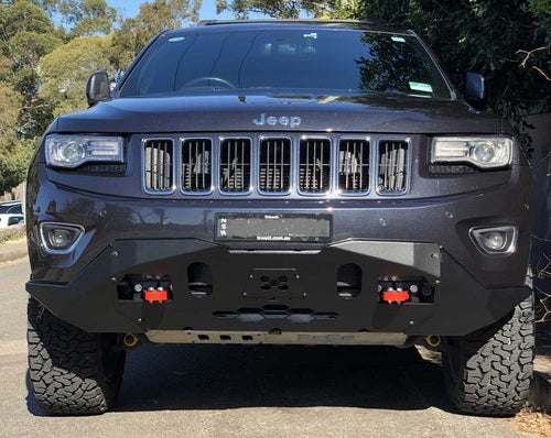 Front view of black Jeep with reinforced bumper, red tow hooks, outdoors.