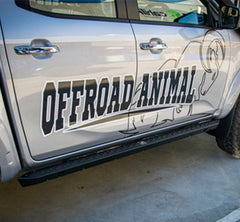 Side view of silver pickup truck with "OFFROAD ANIMAL" text, animal graphic.