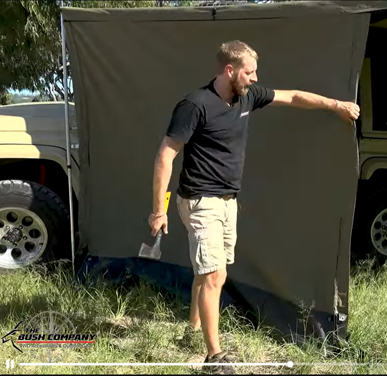 A man holding the tent flap.