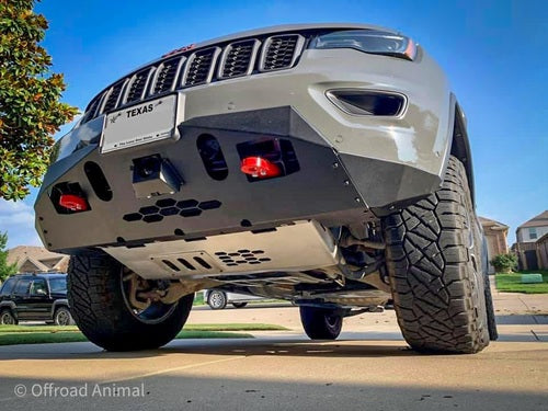 Front view of black Jeep with reinforced bumper, red tow hooks, outdoors.